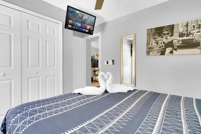 a bedroom with a bed with a towel animal on it at South Facing Pool with Spa and a Game Room in Prime Location Near Disney in Kissimmee