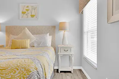 a bedroom with a bed and a lamp on a table at South Facing Pool with Spa and a Game Room in Prime Location Near Disney in Kissimmee