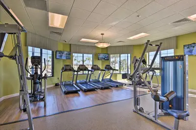 a gym with several treadmills and cardio machines at Kissimmee Getaway with Pool Access 5 Mi to Disney in Kissimmee