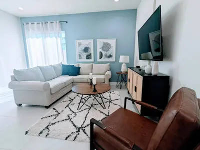 a living room with a couch and a table at Cozy 2024 New 3 Suites 5 min to Disney in Orlando