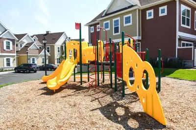 a playground with a yellow slide in a park at Cozy 2024 New 3 Suites 5 min to Disney in Orlando