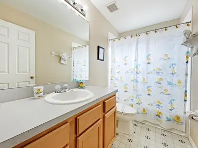 a bathroom with a sink and a toilet and a shower curtain at Sunnyside Villa home in Kissimmee