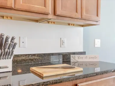 a kitchen with a cutting board on a counter at 6BR w Heated Pool + 9MI to Disney + Sleeps 14 in Kissimmee