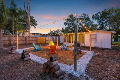 a backyard with a fire pit and a house at Fire Pit + Grill + 2MI to DT Orlando in Orlando