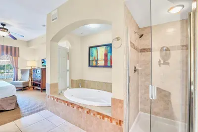 a large bathroom with a tub and a shower at Cozy 2BR Condo Resort Spa with Pirate Pool in Kissimmee