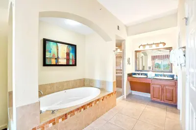 a large bathroom with a tub and a sink at Cozy 2BR Condo Resort Spa with Pirate Pool in Kissimmee