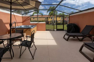 a patio with a table and chairs and an umbrella at Amazing Townhouse for 6 people near Disney in Kissimmee