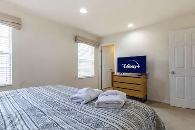 a bedroom with a bed with two towels on it at Amazing Townhouse for 6 people near Disney in Kissimmee