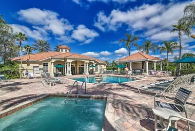 a swimming pool with chairs and a resort at 4 Mi to Disney Emerald Island Resort Home! in Kissimmee