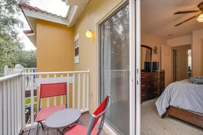 a room with a balcony with a bed and a table and chairs at 4 Mi to Disney Emerald Island Resort Home! in Kissimmee