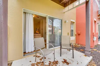 a patio with two chairs and a window at 4 Mi to Disney Emerald Island Resort Home! in Kissimmee