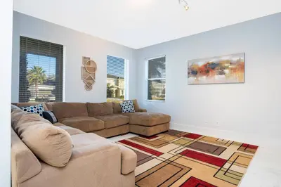 a living room with a couch and a rug at Last Minute Disney Getaway! Private Pool, Hot Tub & Games Room. Book Now! #60493 in Kissimmee