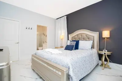 a bedroom with a large bed with blue pillows at Last Minute Disney Getaway! Private Pool, Hot Tub & Games Room. Book Now! #60493 in Kissimmee