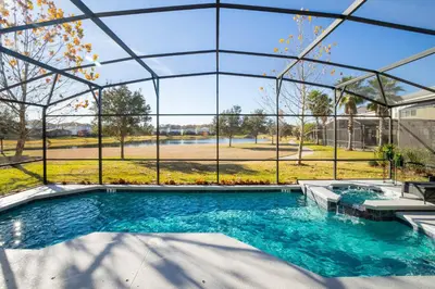 a swimming pool in a building with a large window at Last Minute Disney Getaway! Private Pool, Hot Tub & Games Room. Book Now! #60493 in Kissimmee
