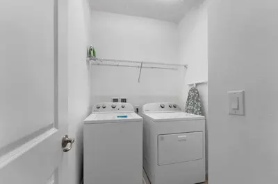 a laundry room with two washer and dryer at Last Minute Disney Private Pool Hot Tub Game Room Themed Bedrooms. Book Now 43123 in Kissimmee
