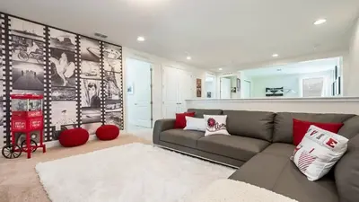 a living room with a gray couch and red pillows at Last Minute Disney Getaway! Private Pool, Hot Tub & Games Room. Book Now! #60535 in Orlando