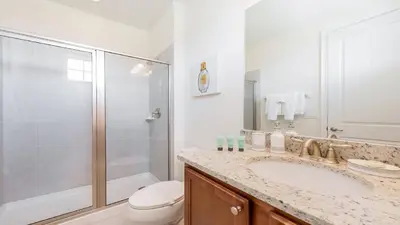 a bathroom with a shower and a sink and a toilet at Last Minute Disney Getaway! Private Pool, Hot Tub & Games Room. Book Now! #60535 in Orlando