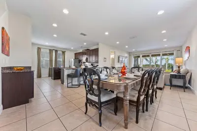 a dining room and kitchen with a table and chairs at Last Minute Disney Getaway! Private Pool, Hot Tub & Games Room. Book Now! #39430 in Orlando