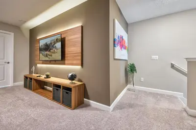 a living room with a wooden entertainment center in a house at Last Minute Disney Getaway Private Pool Themed Bedrooms. Book Now 81937 in Orlando