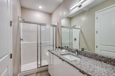 a bathroom with two sinks and a shower at Last Minute Disney Getaway Private Pool Themed Bedrooms. Book Now 81935 in Orlando