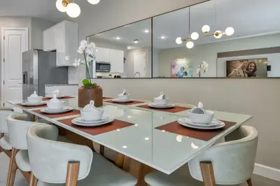 a dining room with a glass table and chairs at Last Minute Disney Getaway Private Pool Themed Bedrooms. Book Now 81935 in Orlando