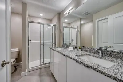 a bathroom with two sinks and a shower at Last Minute Disney Getaway Private Pool Themed Bedrooms. Book Now 81925 in Orlando