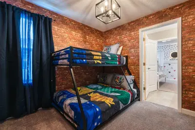 a bedroom with two bunk beds in a brick wall at Last Minute Disney Getaway Private Pool Themed Bedrooms. Book Now 81925 in Orlando