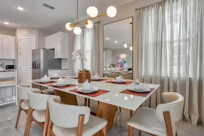 a dining room with a white table and chairs at Last Minute Disney Getaway Private Pool Themed Bedrooms. Book Now 81923 in Orlando