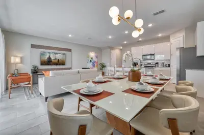 a dining room and living room with a table and chairs at Last Minute Disney Getaway Private Pool Themed Bedrooms. Book Now 81923 in Orlando