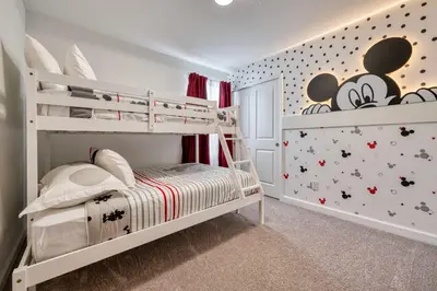 a childs bedroom with a bunk bed with mickey mouse wallpaper at Last Minute Disney Getaway Private Pool Themed Bedrooms. Book Now 81923 in Orlando