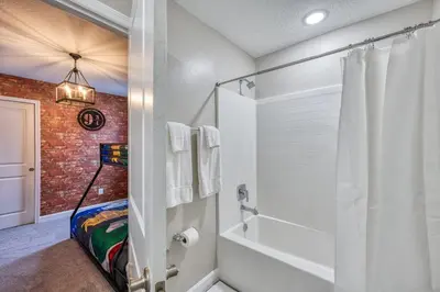 a bathroom with a brick wall and a shower at Last Minute Disney Getaway Private Pool Themed Bedrooms. Book Now 81923 in Orlando
