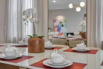a dining room with a table with dishes and a vase with flowers at Last Minute Disney Getaway Private Pool Themed Bedrooms. Book Now 81919 in Orlando