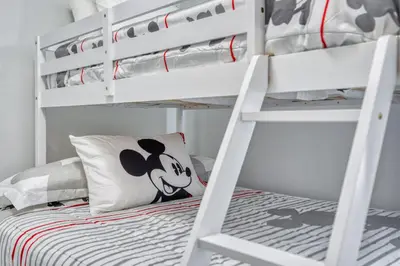 a bedroom with bunk beds with a mickey mouse pillow at Last Minute Disney Getaway Private Pool Themed Bedrooms. Book Now 81921 in Orlando