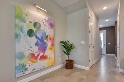 a hallway with a large painting on the wall at Last Minute Disney Getaway Private Pool Themed Bedrooms. Book Now 81915 in Orlando