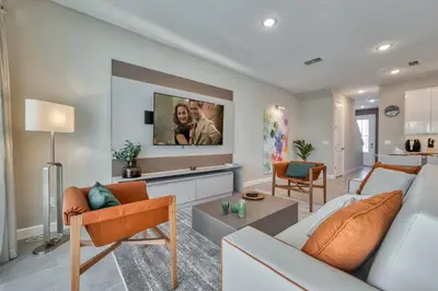 a living room with a couch and a tv at Last Minute Disney Getaway Private Pool Themed Bedrooms. Book Now 81915 in Orlando