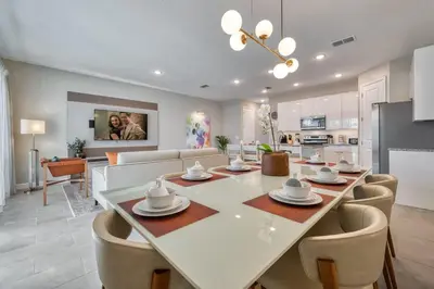a dining room and living room with a table and chairs at Last Minute Disney Getaway Private Pool Themed Bedrooms. Book Now 81915 in Orlando