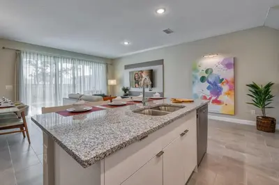 a kitchen with a sink and a living room at Last Minute Disney Getaway Private Pool Themed Bedrooms. Book Now 81917 in Orlando