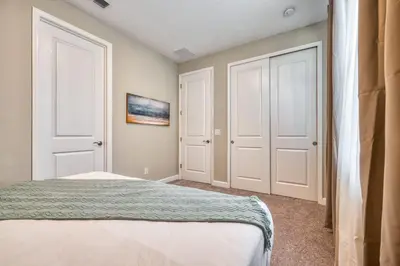 a bedroom with two white doors and a bed at Last Minute Disney Getaway Private Pool Themed Bedrooms. Book Now 81911 in Orlando