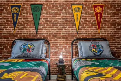two beds in a room with kites on a brick wall at Last Minute Disney Getaway Private Pool Themed Bedrooms. Book Now 81913 in Orlando
