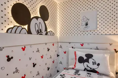 a bedroom with a bed with mickey mouse wallpaper at Last Minute Disney Getaway Private Pool Themed Bedrooms. Book Now 81913 in Orlando