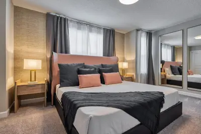 a bedroom with a large bed with two pillows at Last Minute Disney Getaway Private Pool Themed Bedrooms. Book Now 81907 in Orlando