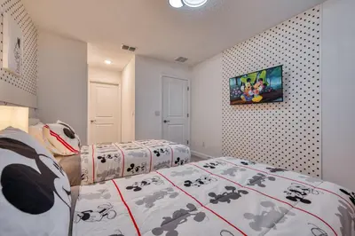 a bedroom with two beds and a painting on the wall at Last Minute Disney Getaway Private Pool Themed Bedrooms. Book Now 81907 in Orlando