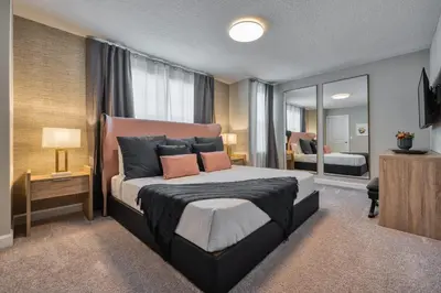 a bedroom with a large bed and a mirror at Last Minute Disney Getaway Private Pool Themed Bedrooms. Book Now 81951 in Orlando
