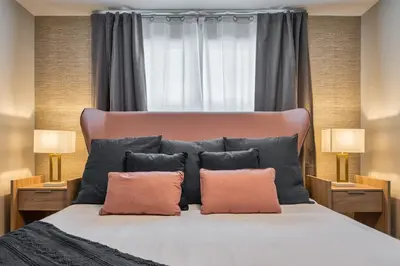 a bedroom with a large bed with two pillows at Last Minute Disney Getaway Private Pool Themed Bedrooms. Book Now 81899 in Orlando
