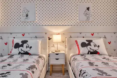two twin beds in a bedroom with hello kitty wallpaper at Last Minute Disney Getaway Private Pool Themed Bedrooms. Book Now 81899 in Orlando