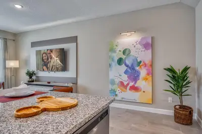 a kitchen with a counter and a painting on the wall at Last Minute Disney Getaway Private Pool Themed Bedrooms. Book Now 81945 in Orlando