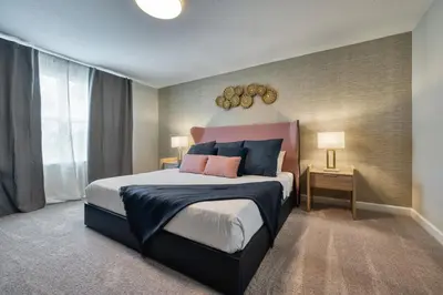 a bedroom with a large bed with blue and pink pillows at Last Minute Disney Getaway Private Pool Themed Bedrooms. Book Now 87413 in Orlando