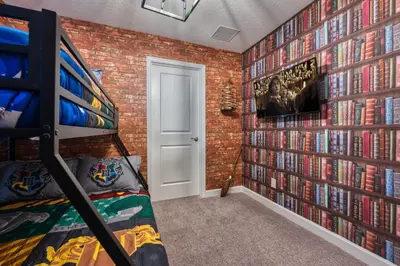 a bedroom with a wall of dvds at Last Minute Disney Getaway Private Pool Themed Bedrooms. Book Now 87413 in Orlando