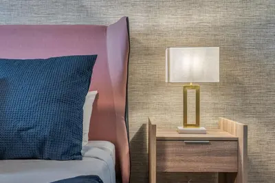 a bed with a table with a lamp on it at Last Minute Disney Getaway Private Pool Themed Bedrooms. Book Now 91347 in Orlando