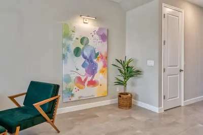 a room with a chair and a painting on the wall at Last Minute Disney Getaway Private Pool Themed Bedrooms. Book Now 91347 in Orlando